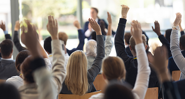 Team actively participating in a strategy session inside a modern, light-filled meeting space
